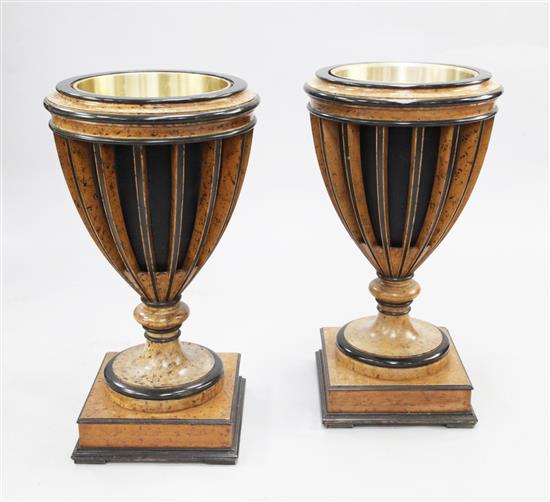 A pair of simulated burrwood and ebonised urns, H.2ft 9in.